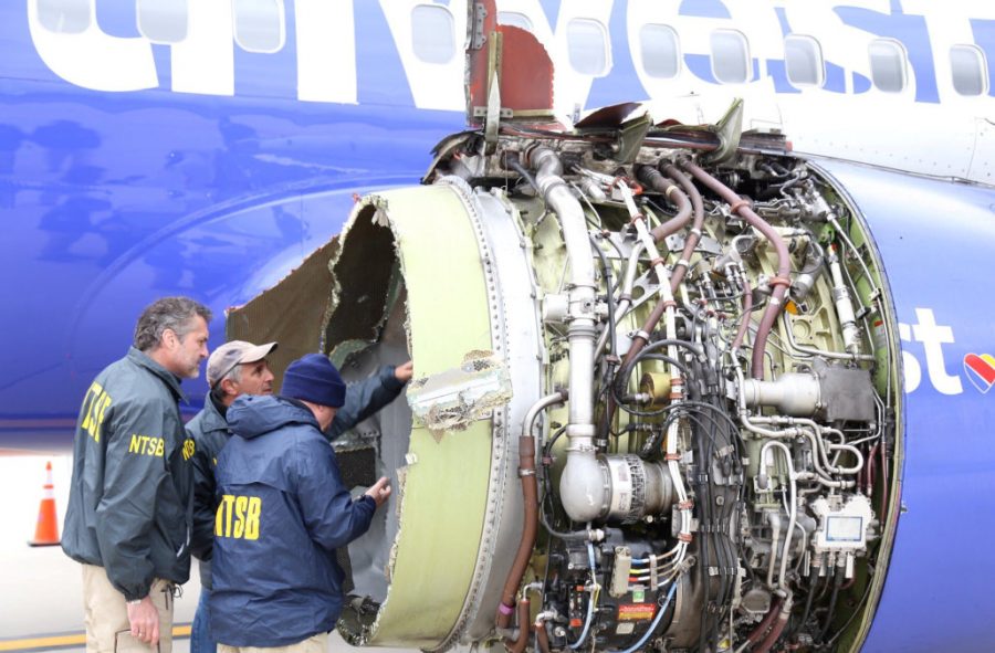 U.S. NTSB investigators are on scene examining damage to the engine of the Southwest Airlines plane in this image released from Philadelphia, Pennsylvania, U.S., April 17, 2018.    NTSB/Handout via REUTERS  ATTENTION EDITORS - THIS IMAGE HAS BEEN SUPPLIED BY A THIRD PARTY.     TPX IMAGES OF THE DAY