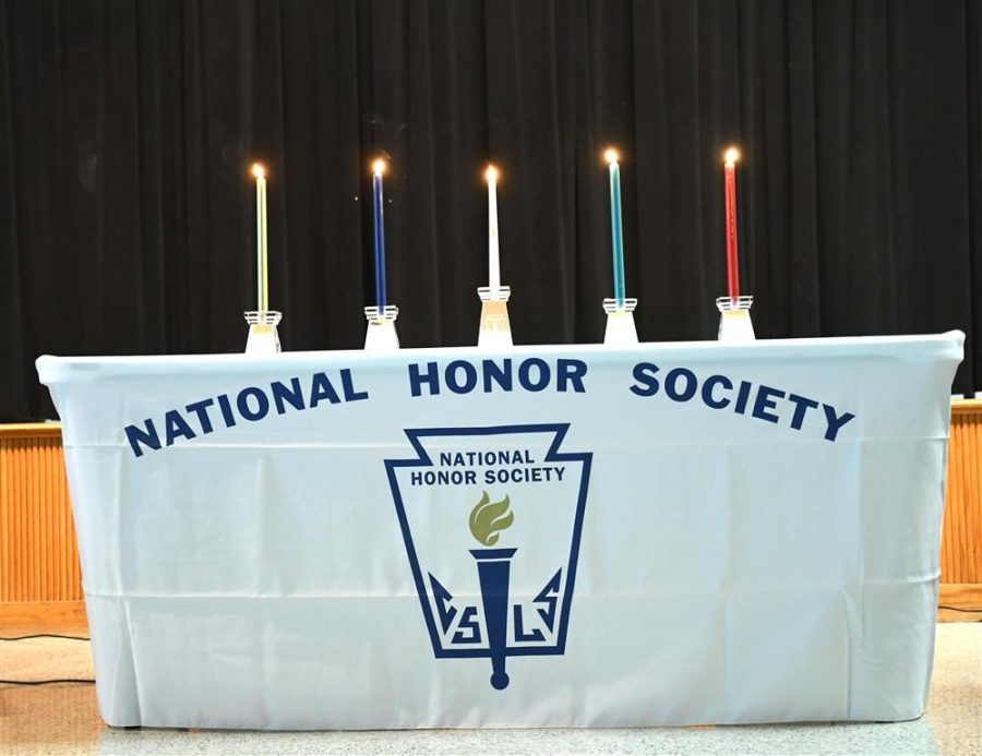 The four lit candles representing the four pillars of NHS. 