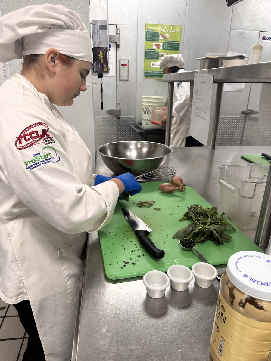 Cat Gutierrez cutting Basil for house dressing