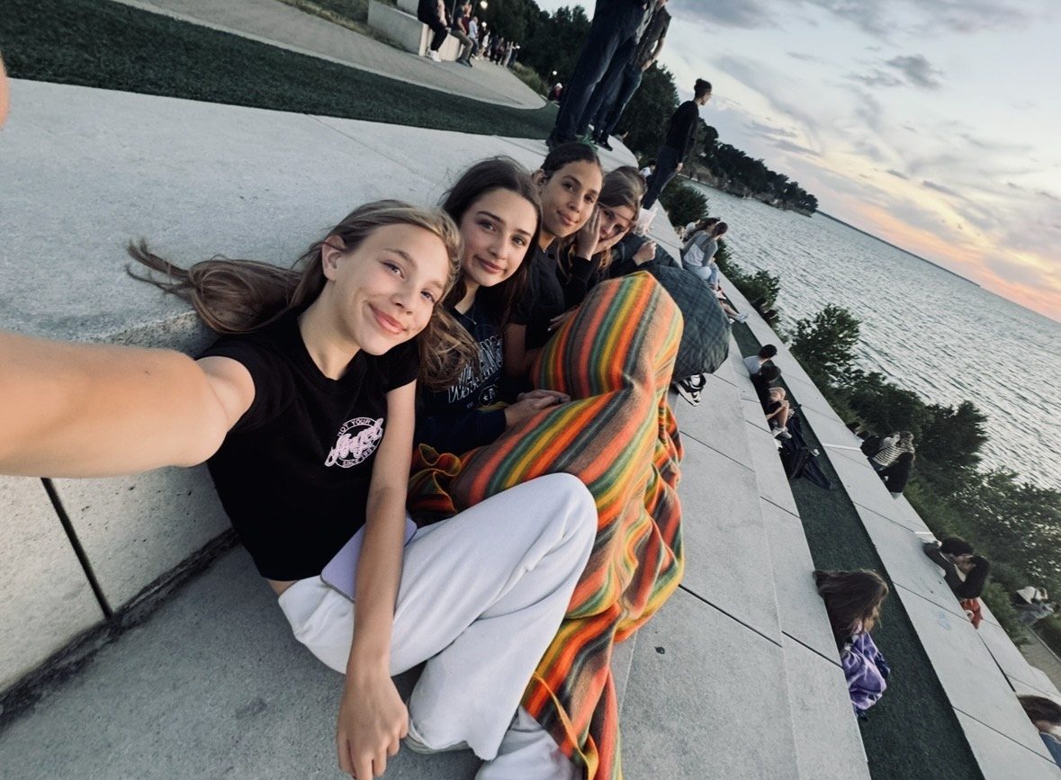 Local Lakewood residents, Lyla Parkison, Mia Dugan, Ariana Hueter, and Alice Paynter gather around for a cozy evening on the steps.