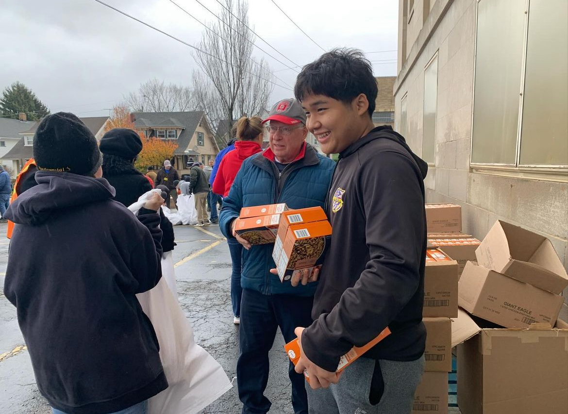 Student volunteer Moo Blue Soe from the LHS Boys Soccer team finishes packing the donations.