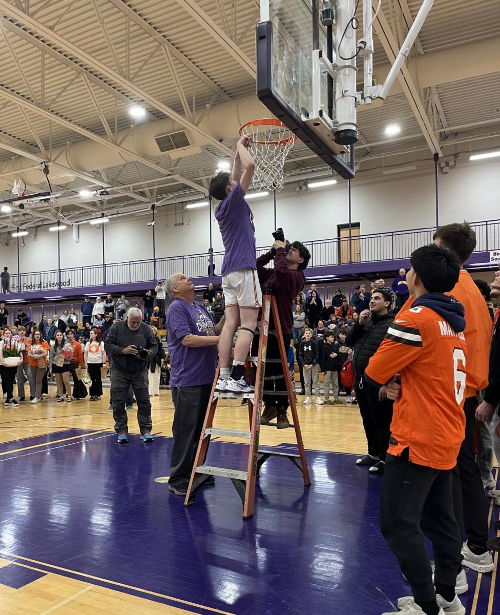 After beating the Rocky River Pirates, senior Lucas Seguine was the first player from the varsity team to cut down part of the net after the big game.