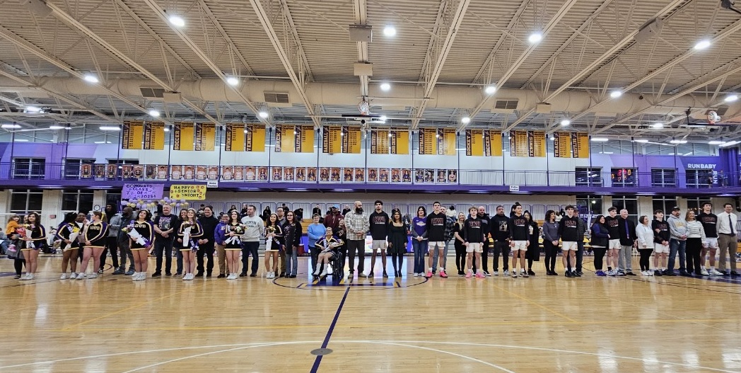 The seniors of the Rangers boys' basketball team and the cheer team line up for a photo in celebration of Senior Night.