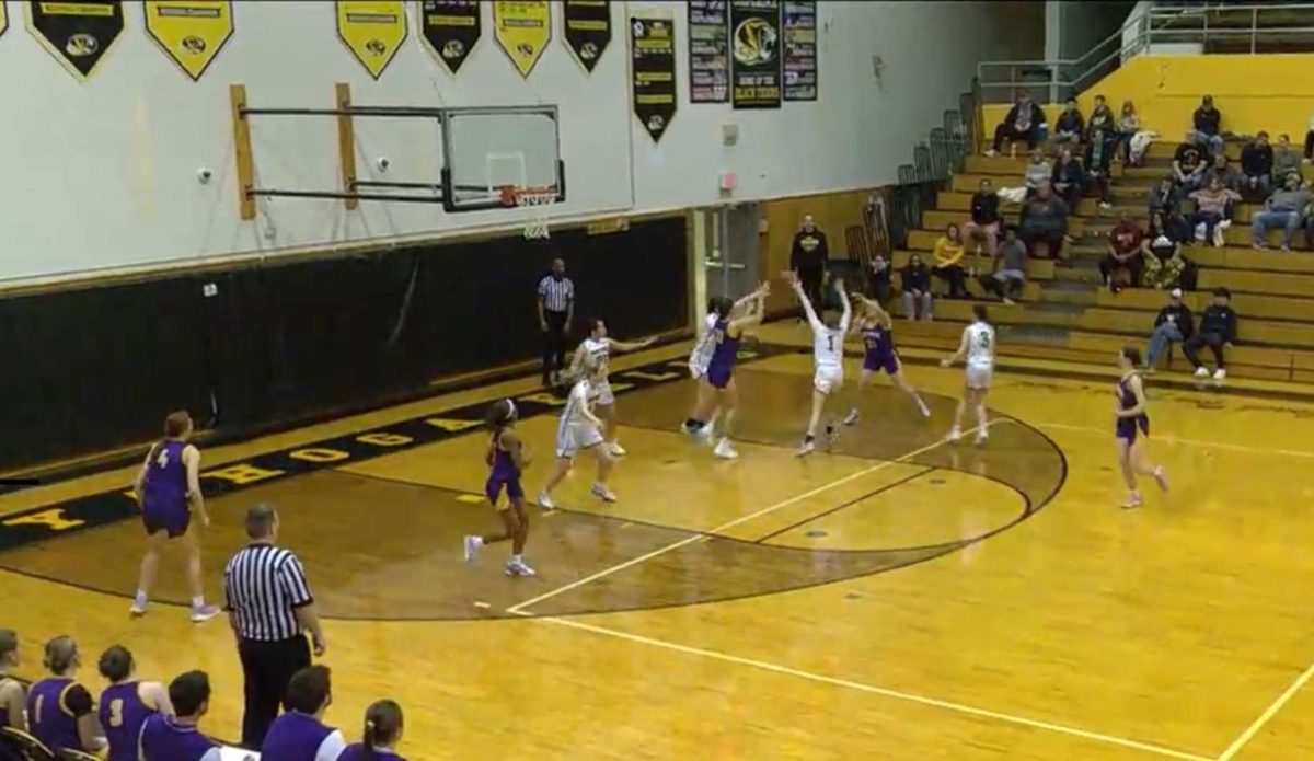 The girls' basketball team plays hard on the court during their playoff game at Cuyahoga Falls against the Tigers. 