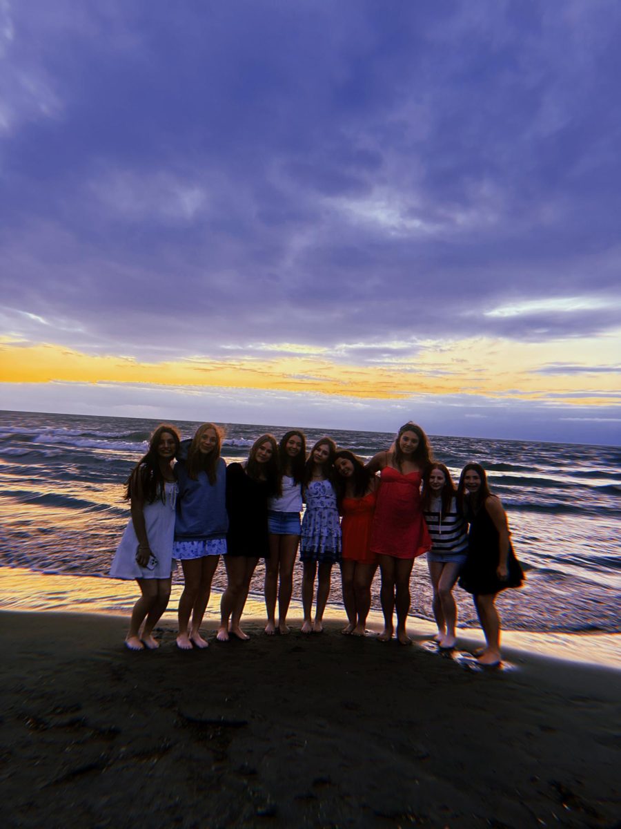 Edgewater Beach at dusk, where golden light meets laughter, and the shoreline holds memories you didn't know you were making.