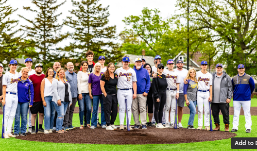 Lakewood Baseball Seniors line up together with their families after walking out onto the field. 