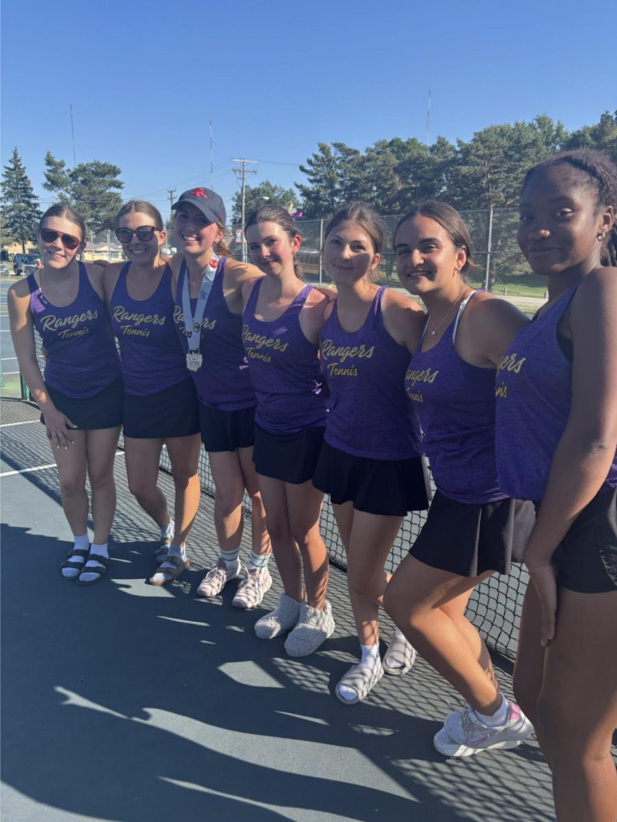 The girls' varsity tennis team celebrates a nice day of competition.