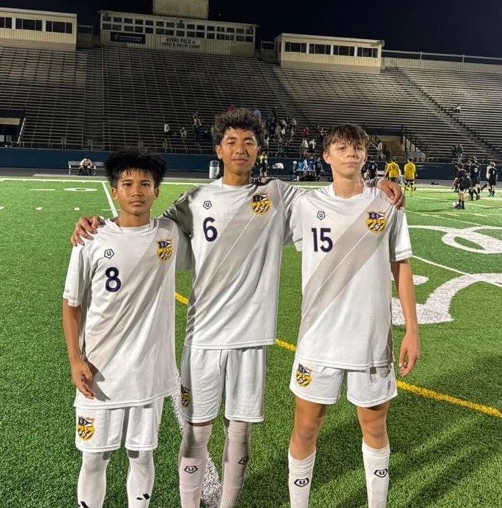 Lian, Aaron, and Will posing after their hard work on the pitch.