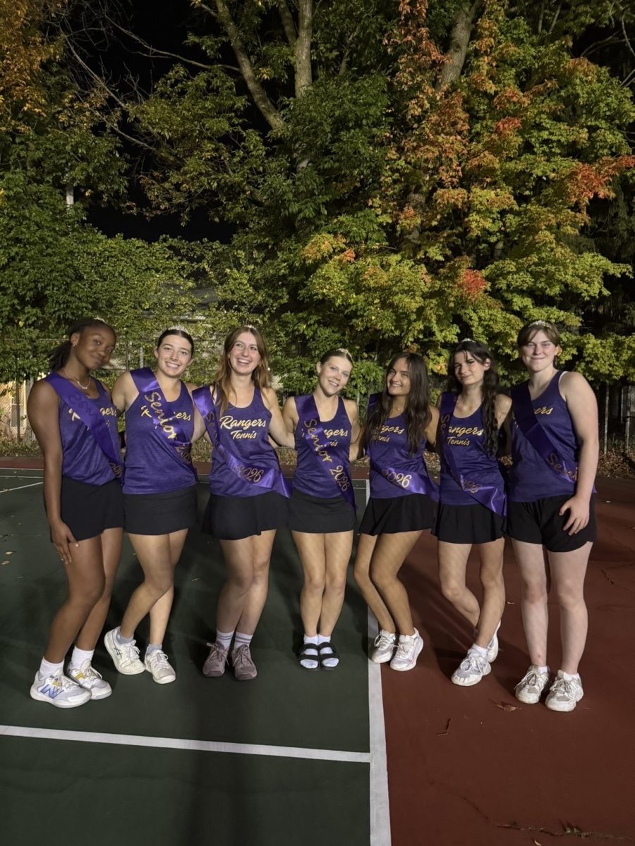 The girls' tennis seniors line up to celebrate a great year.