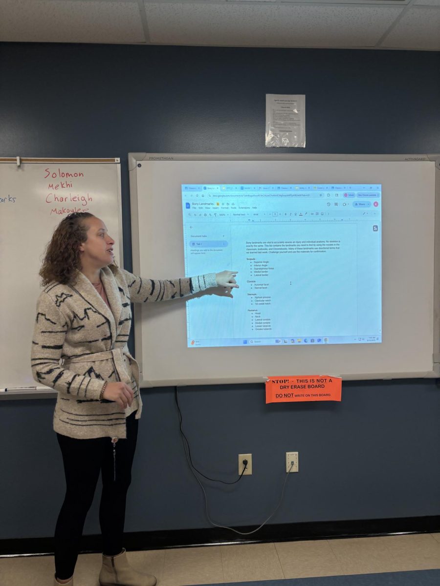 Caruso guiding her junior class through notes and a future lab.