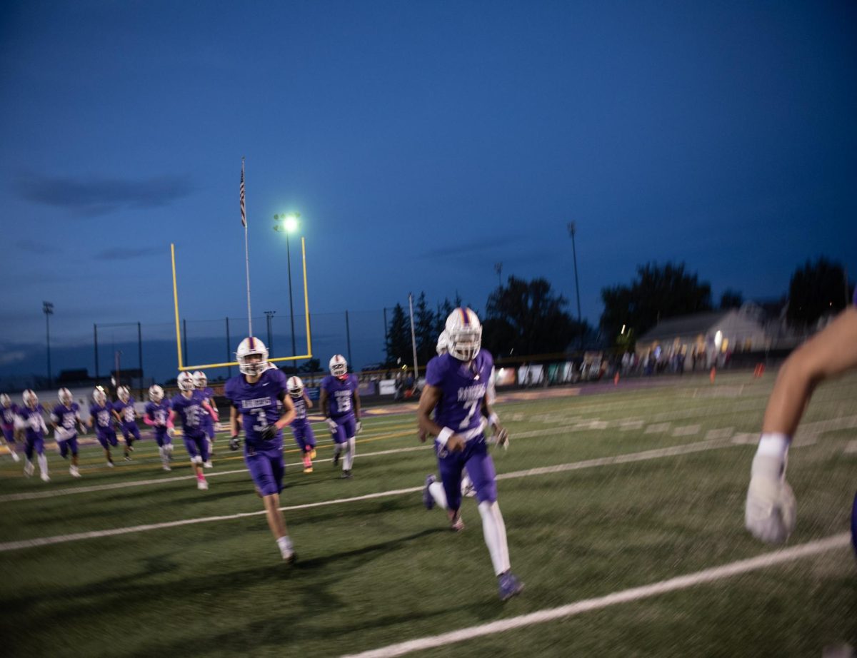 The football team runs out, ready to play.