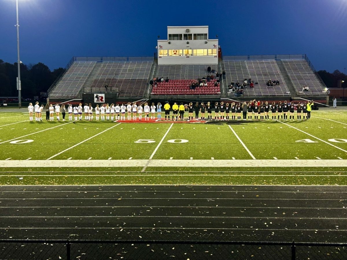 Lakewood and Roosevelt line up for a uniform check before their game.