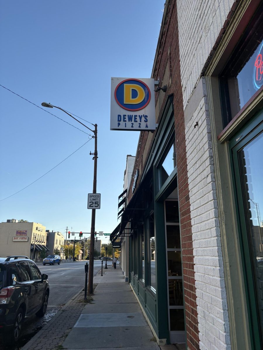 A sign for Dewey's Pizza before walking into the diner.