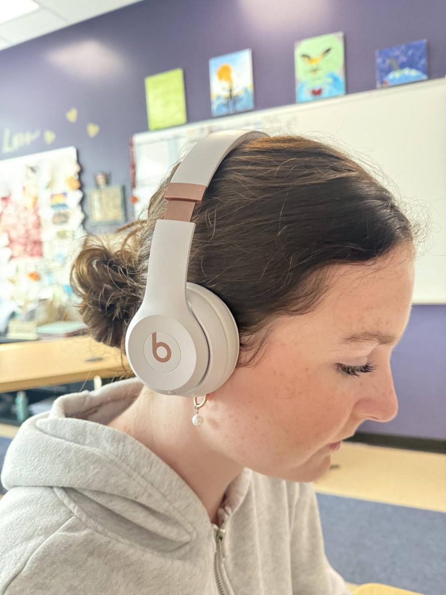 Grace Liderbach listens to music while working in her first-period class.