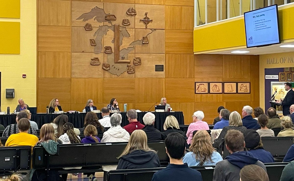 Members of the Lakewood School Board and attendees listen to a presentation highlighting the benefits of early childhood education.