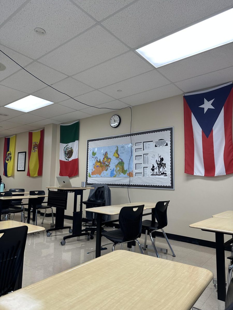 Inside a Spanish classroom, decorated with flags from Spanish-speaking countries.