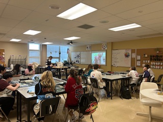 Dayna Hansen demonstrating an art piece for her pARTners class.