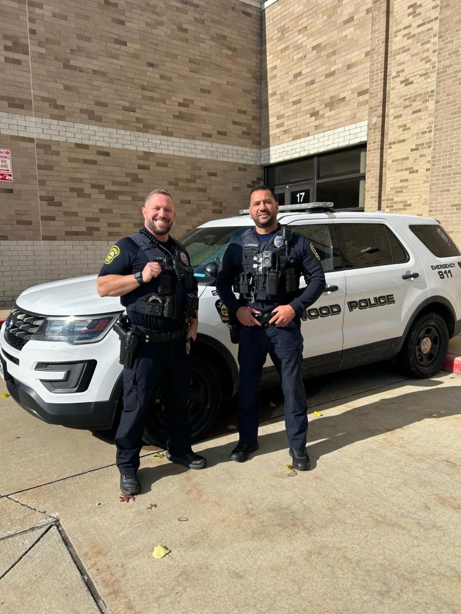 Officer Betts and Officer Jameson with their police cruiser, ready for the day.