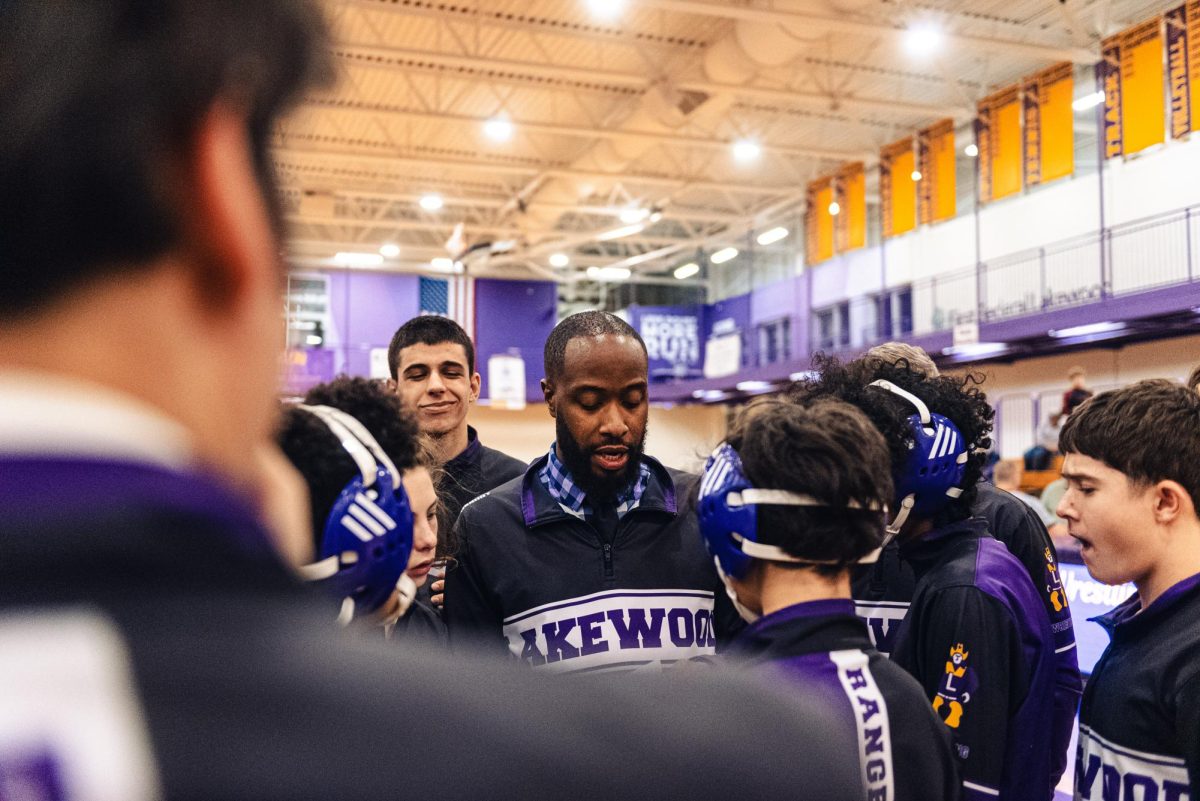 The wrestling coach meets with the team.