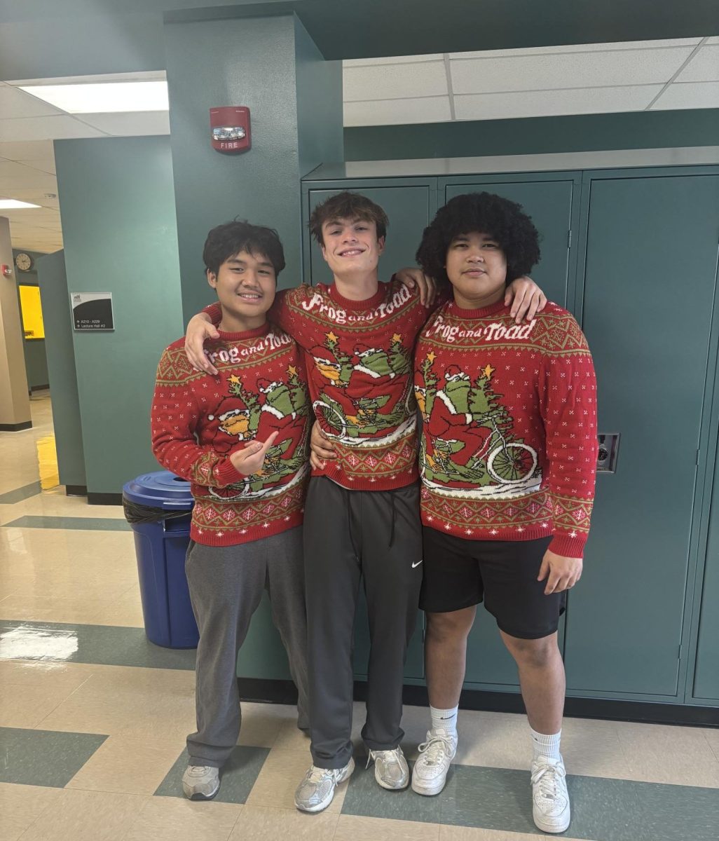 Seniors Moo Blue Soe, Jacob Stoll and Isaac Norris strengthen their bond as they match on Silly Sweater Day.