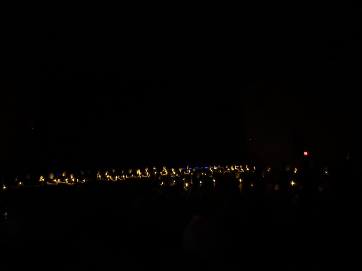 Students sing "Silent Night" by candlelight at the opening of the LHS choral concert.