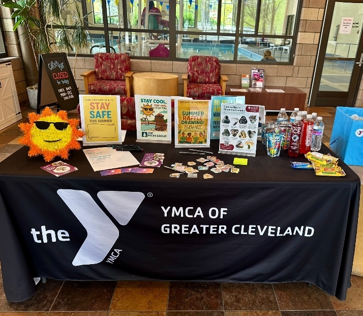 A table set up at the Lakewood Family YMCA with stickers, snacks and educational fliers. 