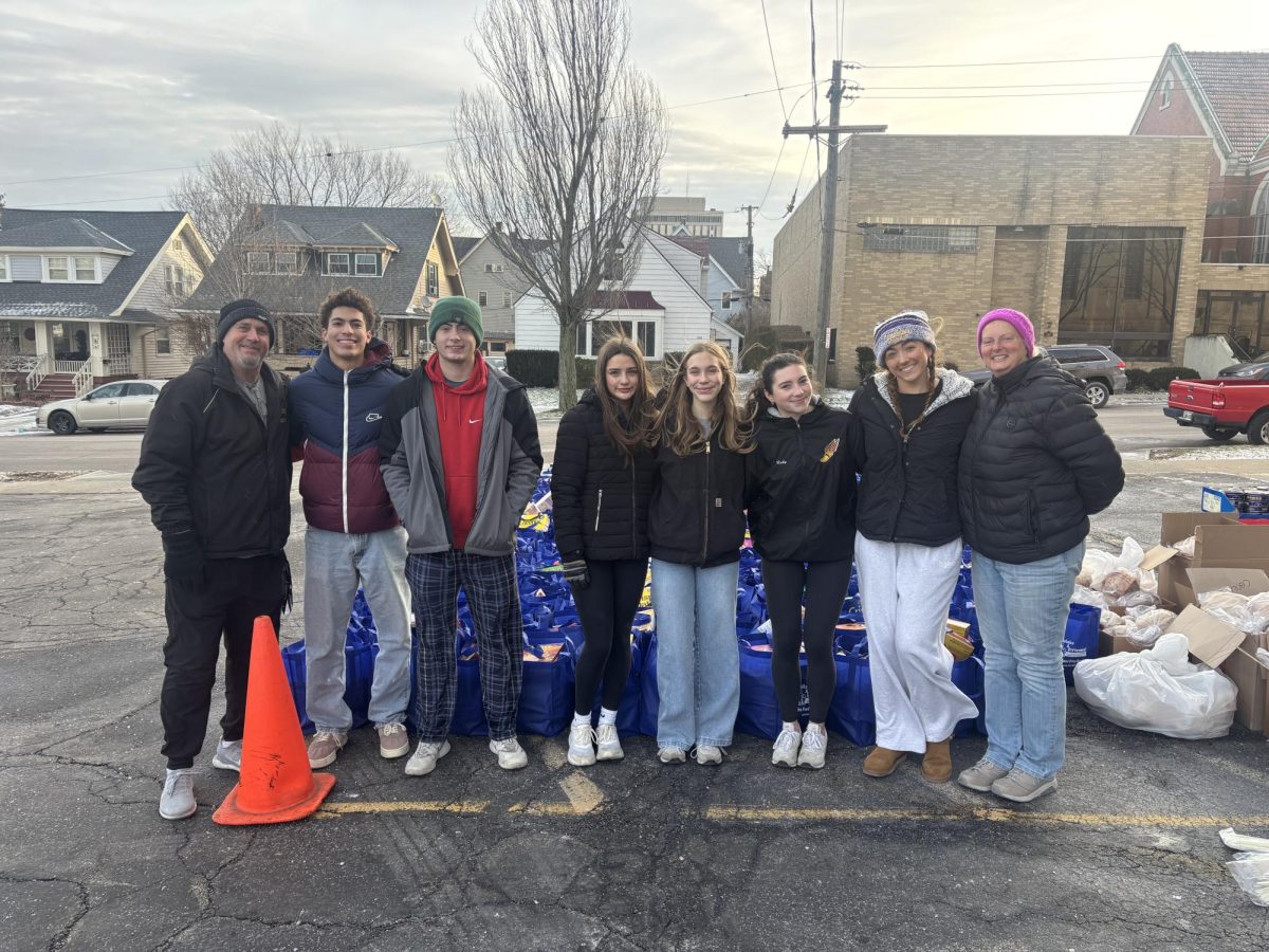 The SALT team takes a break from loading bags (From left to right: Rob Slone, Nyle Donaldson, Ethan Moore, Mia Dugan, Lyla Parkison, Ruby McEwen, Ella Bower, Colleen Clark-Sutton)