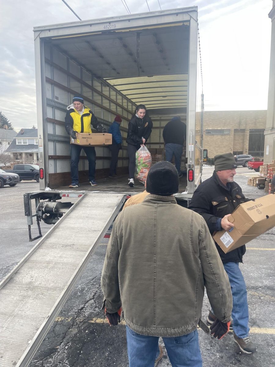 Ruby McEwen unloads a bag of carrots for the volunteers below.