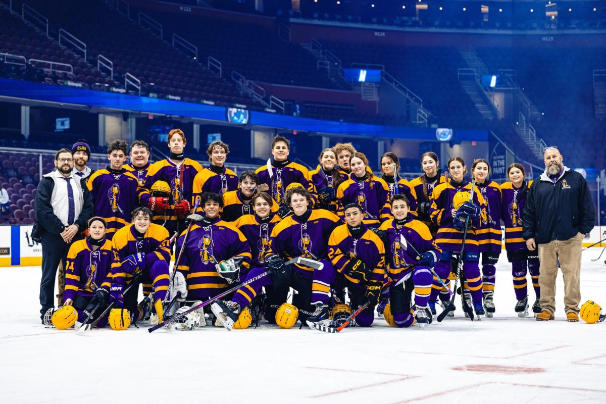 The Lakewood hockey team gathers together after a game at Rocket Arena.