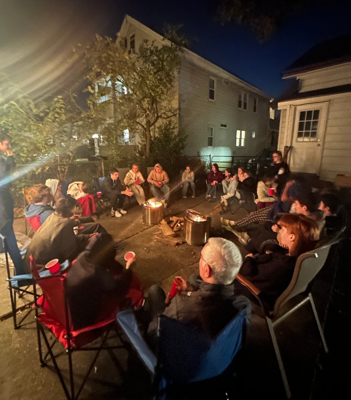 Young Life participants gather around a fire, sharing stories.