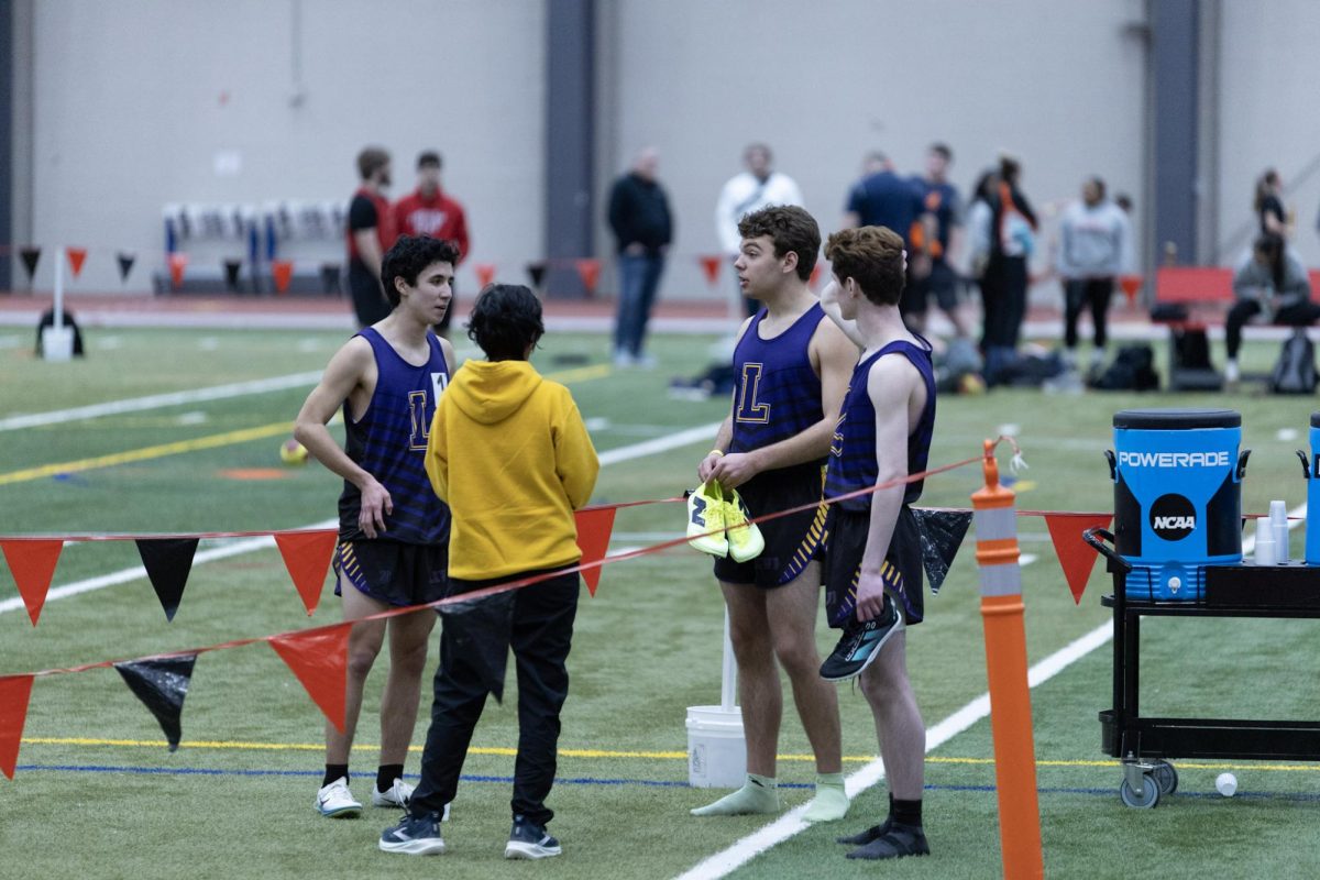 The boys 4x800m team reconvene with Coach Hernandez.