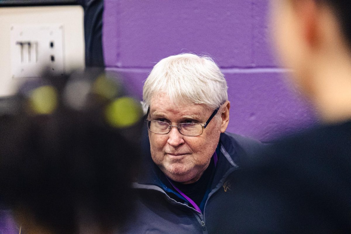 Coach Glunt talks with his team during a meet.