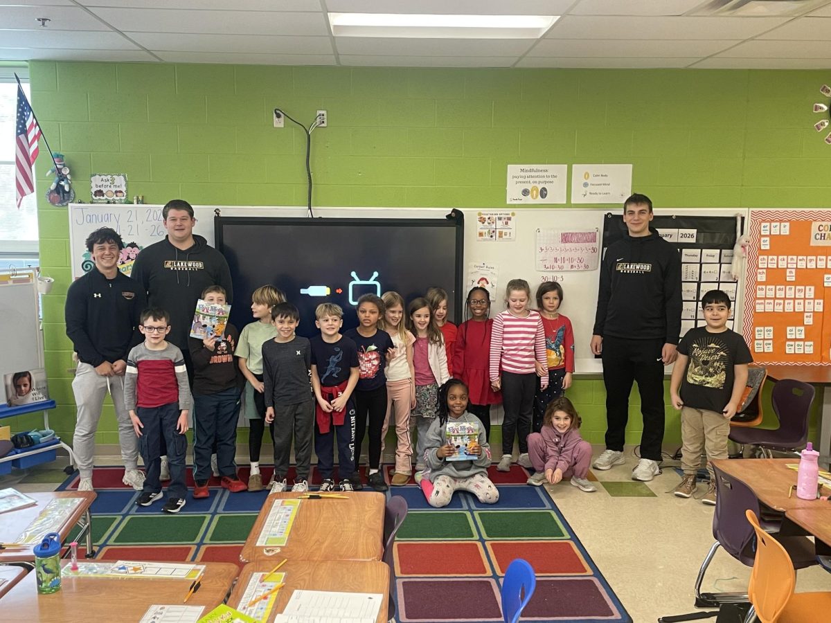 Cooper Russel, Jackson Comer, and Riley Verderber pose for a picture with their students after a successful trip to Grant.
