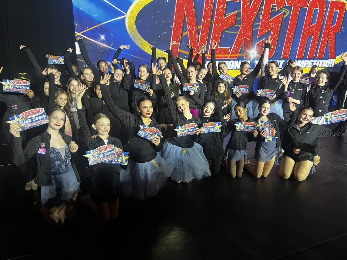 Full team smiles after a successful awards ceremony.
