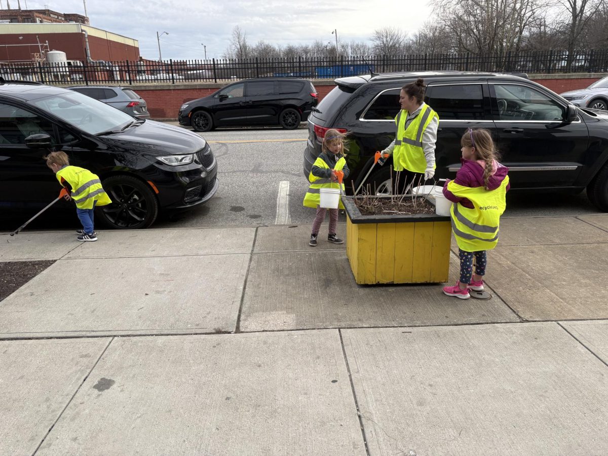Volunteers of all ages work to keep the streets clean.