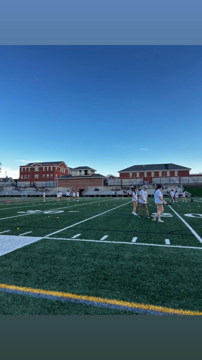 Girls' Lacrosse warms up for the dedication game.