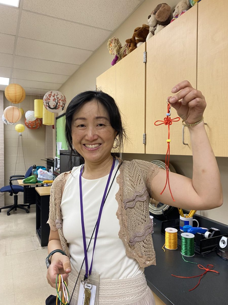 Piwen Ku showing the Lucky Knot she made.